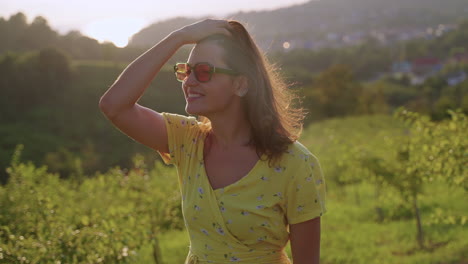 woman enjoying a golden sunset view in a field