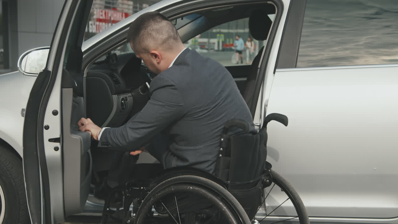 Businessman Getting Out of Car and Getting into Wheelchair