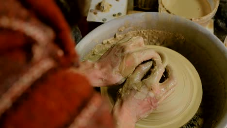 professional male potter working in workshop