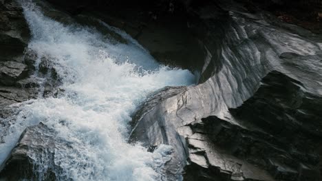 the torrent of the whitewater rushes over the rocks