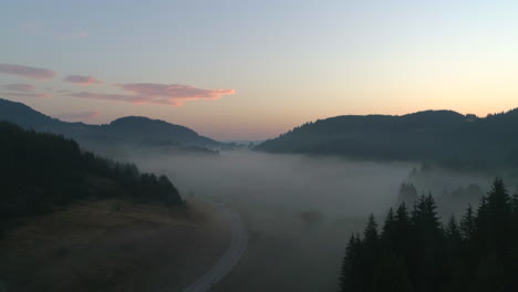 a-road-to-a-misty-field-in-a-mountainous-area