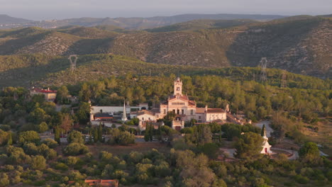 buddhist temple captured by drone in majestic mountain valley aerial footage at golden hour sunrise