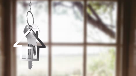 house-shaped keychain and keys animation over blurred window background