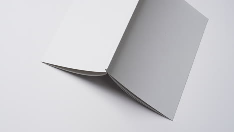 Video-of-book-with-white-blank-cover-pages-and-copy-space-on-white-background