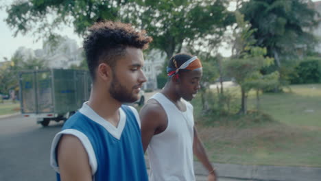 basketball buddies walking along the street, dribbling ball and chatting