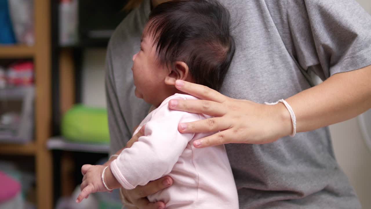 Baby born in mother's arms crying with nausea