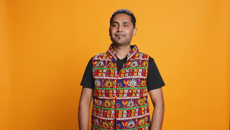 retrato de un hombre optimista con un chaleco de colores, telón de fondo de estudio