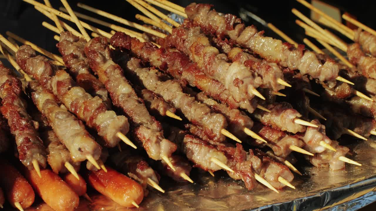 Pork meat skewer on fire, Mutton barbecue close-up. Fried meat for kebab. Cooking grilled meat beef chicken lamb BBQ . Kebab on grill. Chinese street local market with traditional food. Asian fast food.