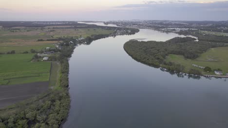 maroochy river at dusk - picturesque waterway flowing through green foliage in queensland, australia