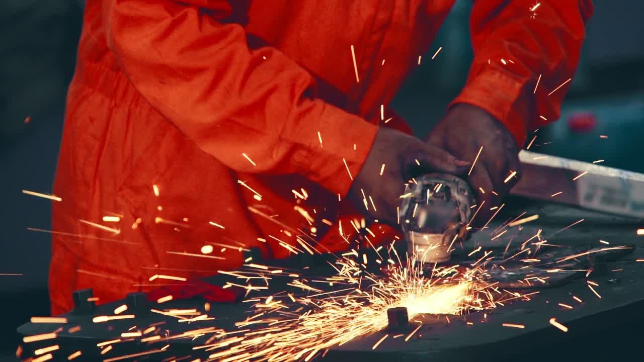 Professional mechanic is cutting steel metal.
