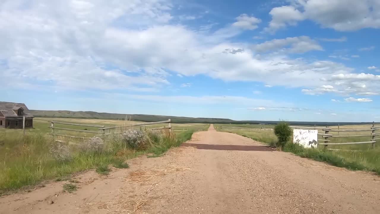 Traveling down a dirt road in the country on a sunny day during the summer.