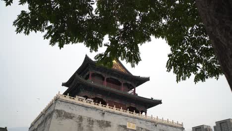 ancient chinese tower in tianjin, flying birds