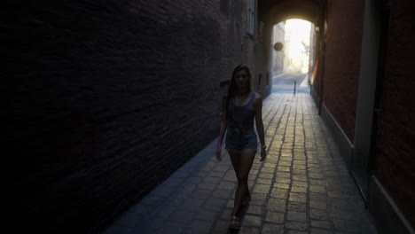 woman walking down a city alley