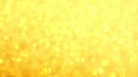 decorative defocused abstract gold background with sparkling glitter. festive and holiday background for text. 4k footage