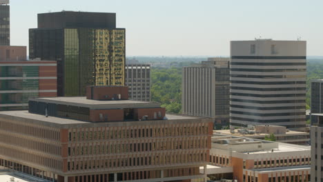 aerial midlevel view of downtown city with a pan showing skyline