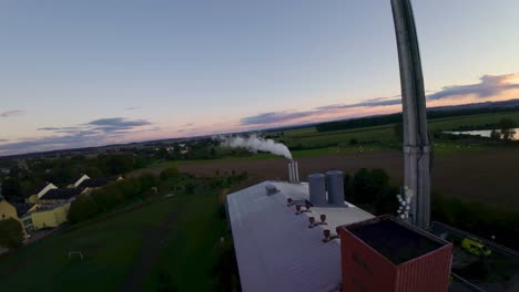 chimney of a heating plant smoking white smoke when heating water for households