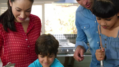 -Cute-family-preparing-a-cake