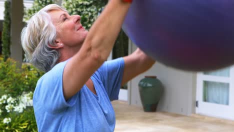 senior woman exercising with fitness ball