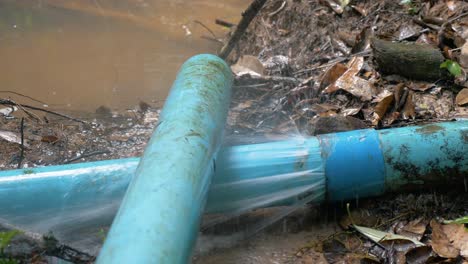 Broken-or-leaking-Industrial-pipe-with-water,-water-leakage-from-damaged-rusty-pipe,-slow-motion