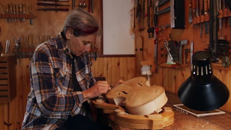 female luthier at work in her workshop