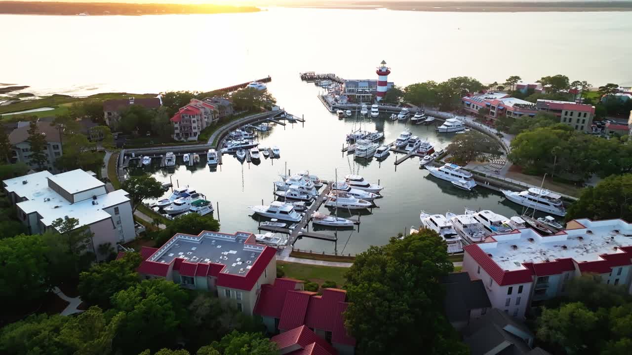 Sunset light over trees and water near harbor town pier, vibrant color tones reflected, Harbour Town Pier South Carolina USA