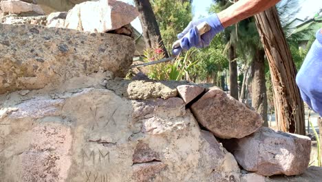 latin man bricklayer placing cement for construction