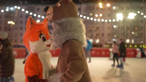 animal mascot entertainment at an outdoor ice skating rink at night