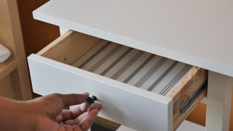 person opening and closing a drawer