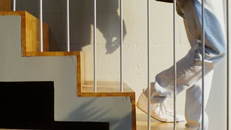 person walking up modern wooden stairs