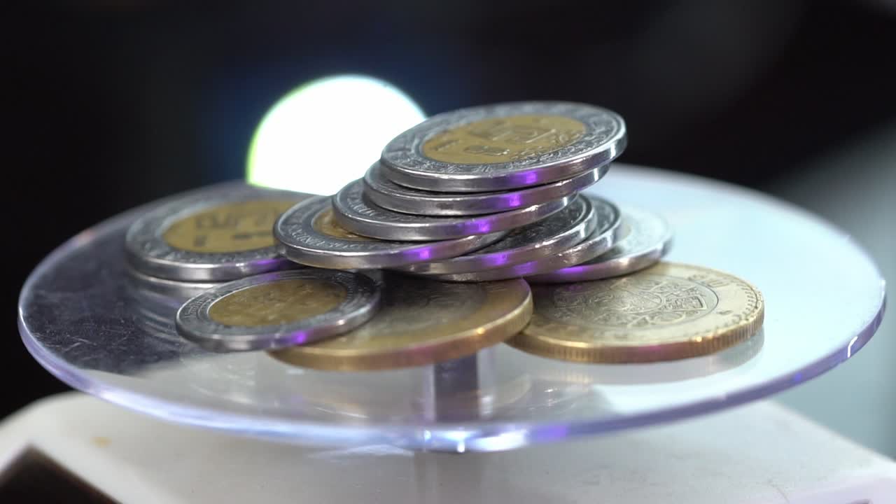 Mexican Peso coins on a digital scale, a concept of economy and inflation