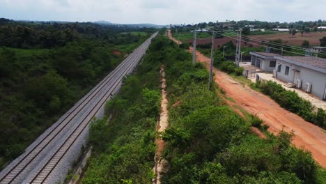 beautiful aerial of a long railway running through the beautiful landscape of rural nigeria, africa