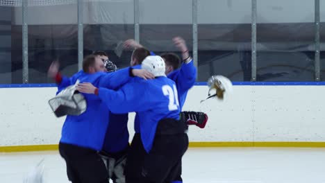 hockey players celebrating goal on ice rink