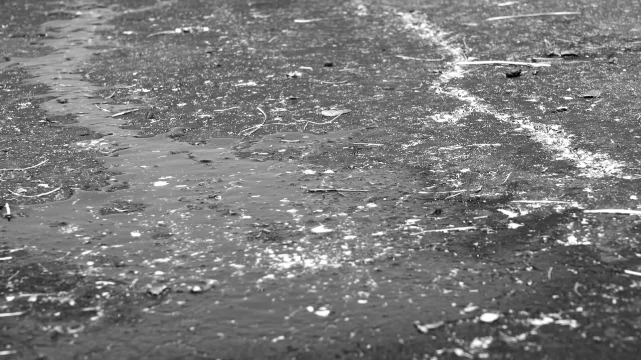 A high angle viewed in black and white of wet pavement