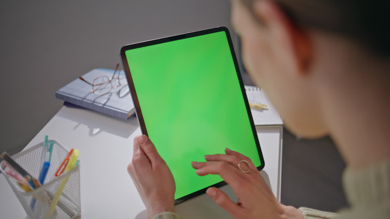 Student using chromakey tablet on workplace closeup. Woman hands working mockup