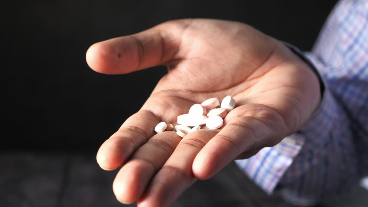 Hand holding pills