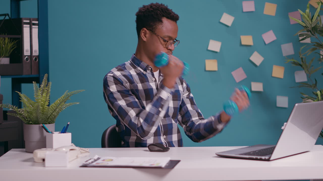 Athletic worker lifting weights with dumbbells to train muscles