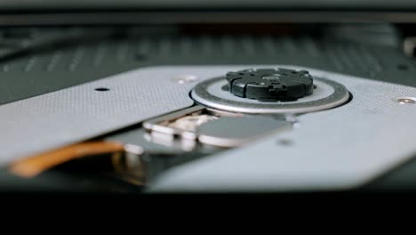 close-up shoot of a person ejecting a cd from a portable device.