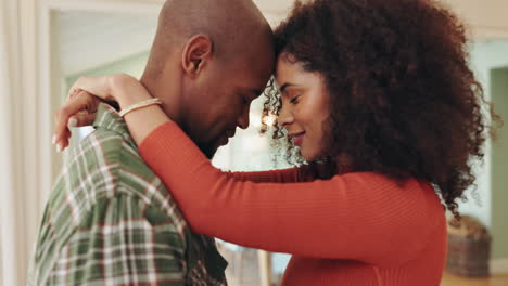 an affectionate couple embracing at home