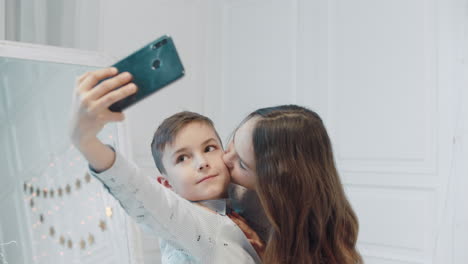 smiling boy and girl making selfie photos together.