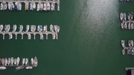 Yacht-aerial-drone-view-Top-view-of-Boats-docked-at-harbor,-marina-pier