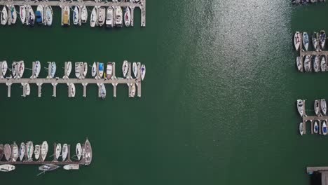 yacht aerial drone view top view of boats docked at harbor, marina pier