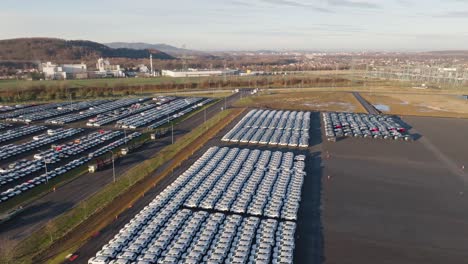 aerial - huge parking lot parked with new combustion engine vehicles