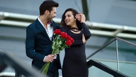 Close-up-young-couple-meeting-at-street.-Business-man-and-woman-smiling-outdoors