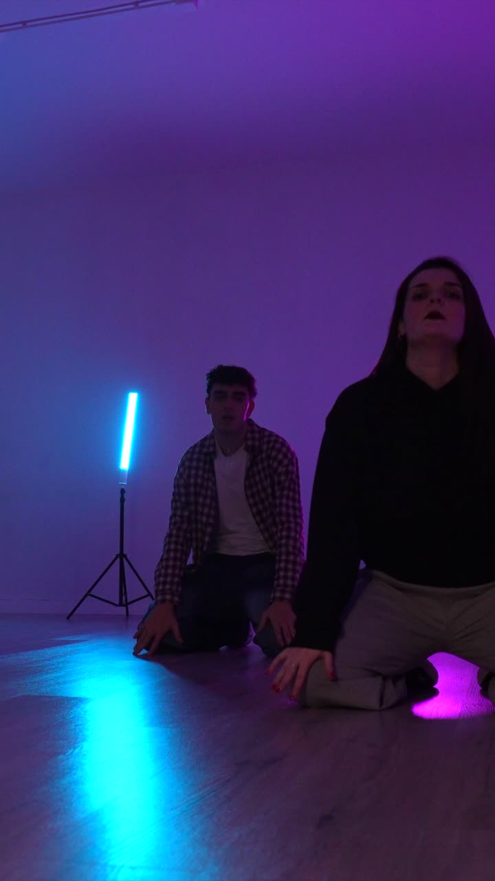 People dancing in a dance studio with neon lights