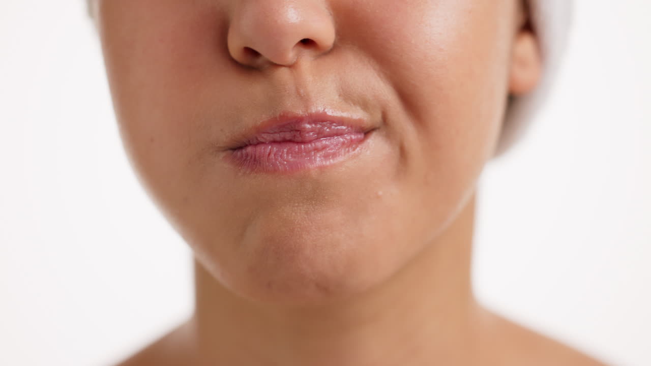 Close-up of a woman using mouthwash