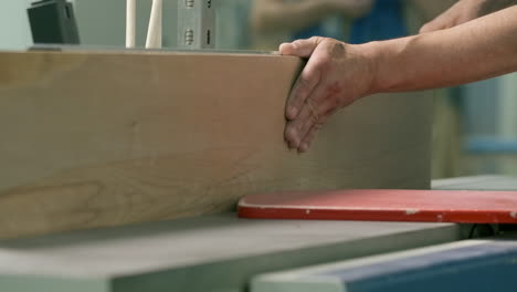 wood plank being planed on a jointer