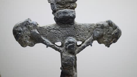 an antique relic depicting jesus christ on the cross from the medieval period