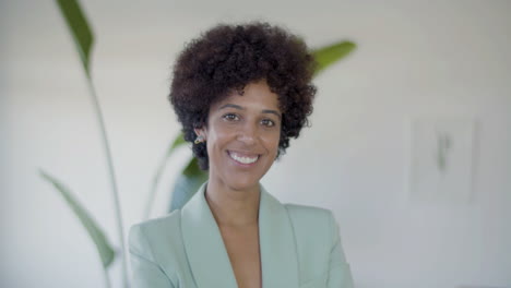 portrait shot of happy female office worker in elegant green blazer