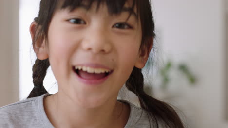 portrait of happy little asian girl laughing playfully having fun positive childhood 4k footage