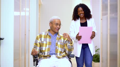 Positive-black-woman-bear-handicapped-colleague-walking-in-office